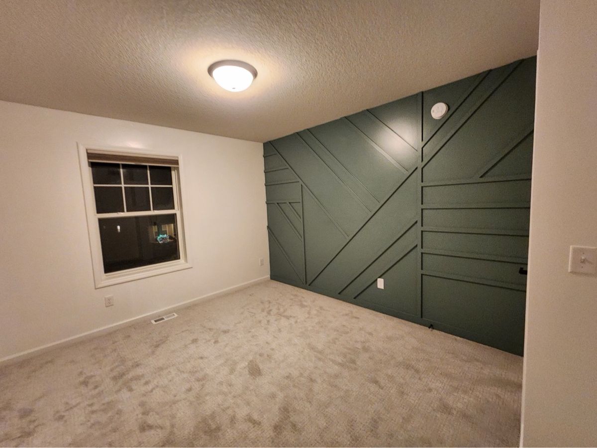 Green geometric accent wall designed and built by The Hillcrest Company