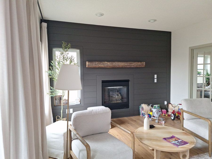 Finished interior with a deep-color fireplace wall and fresh white trim, painted by The Hillcrest Company