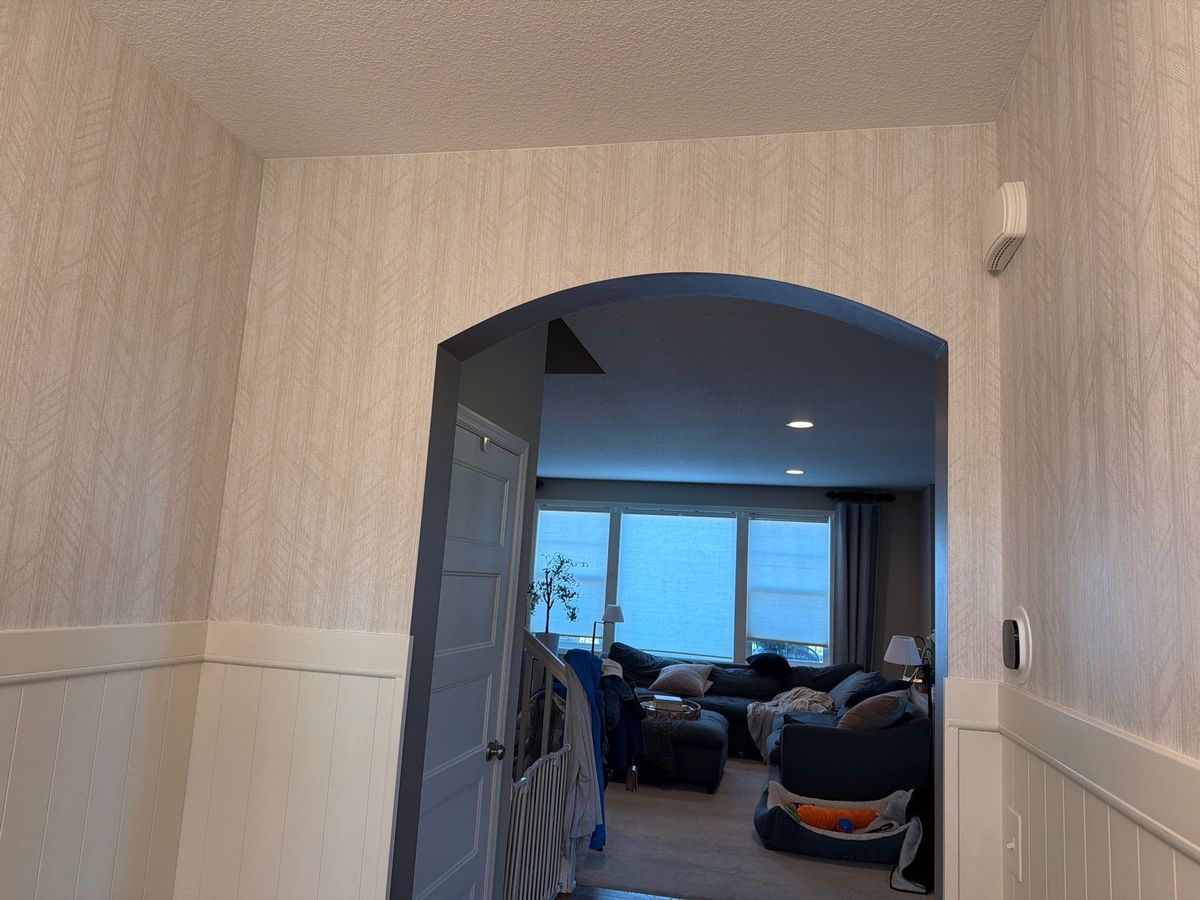 Wallpaper pattern matched around an archway, installed by The Hillcrest Company